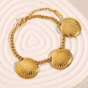 Detailed macro shot of 18K gold-plated stainless steel bracelet with realistic shell pendants