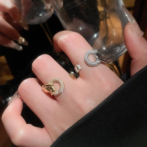 Detail of a leopard head ring with pavé zircons worn during a luxury dinner event