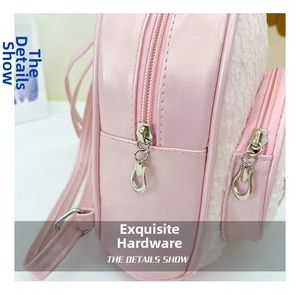 Close-up of pink leather backpack featuring shell sequins and silver dual zipper detail