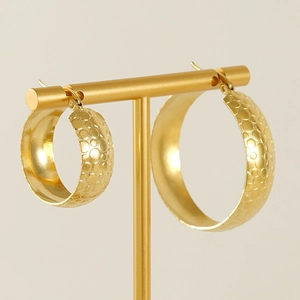 Exaggerated wide hoop earrings with bubble texture and 18K gold plating on T-stand