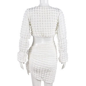 Rear view detail of white popcorn textured two-piece set with long sleeve crop top