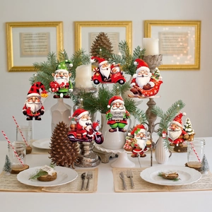Festive table setting with wooden Santa Claus ornaments, pine cones and warm candles