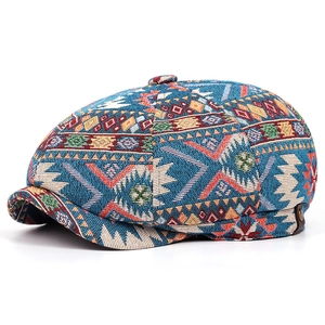 Detail of bohemian newsboy cap showing ethnic jacquard fabric and leather buckle strap