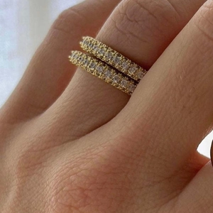 Set of two 18k gold plated eternity rings with sparkling cubic zirconia on finger