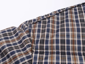 Detailed close-up showing the plaid pattern stitching and fabric texture of the jacket