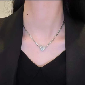Silver layered heart necklace featuring sparkling diamonds and elegant snake chain
