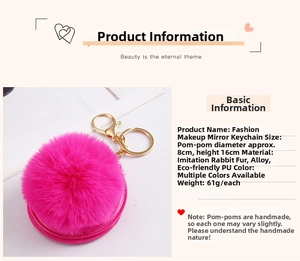 Detail view of the rose red faux fur ball keychain with its folding makeup mirror