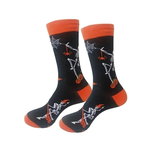 Close-up of Halloween crew socks featuring skull, spider web and pumpkin knit patterns