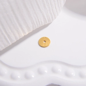 Macro shot of S925 sterling silver flat round spacer beads with gold plated finish