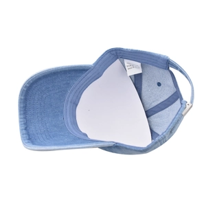 Detail of adjustable metal buckle and 100% cotton wash label on washed denim baseball cap