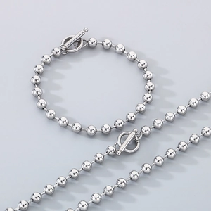 Polished stainless steel bead necklace and bracelet set with toggle OT clasp detail