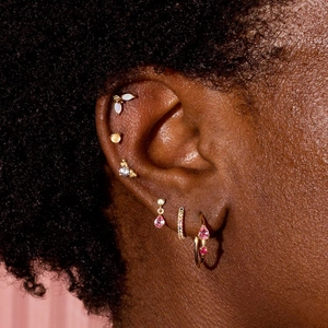 Detail of S925 silver gold-plated stud earrings featuring opal and marquise-cut gems