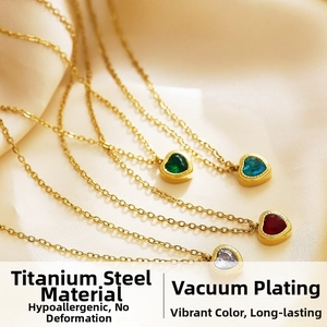 Macro shot of titanium steel heart necklaces with colorful zircon stones in gold finish