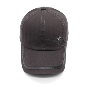 Detail of dark taupe cotton baseball cap with maple leaf badge and stitched brim