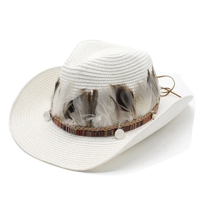 Detail of white straw cowboy hat featuring feathers, woven band and metal disc charms