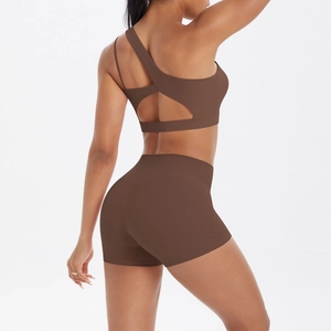 Women's chocolate brown one-shoulder sports bra and high-waist shorts set from back view