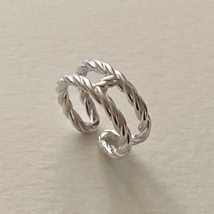Close-up of double-layered sterling silver ring with twisted rope design and open band