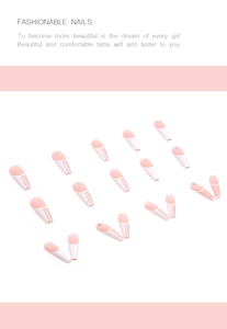 Detail of French press-on nails with pink line patterns and delicate rhinestone accents