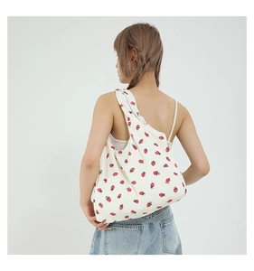 Detail of strawberry print corduroy tote bag showing material texture and pattern