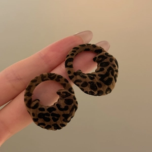 Close-up of leopard print flocked circular earrings with soft velvet texture for women
