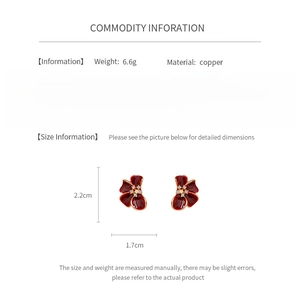 Detail view of red enamel flower earrings with dimensions and material specifications