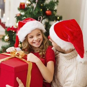 Thick plush red Christmas hat with white pom-pom shown in a cozy festive holiday setting