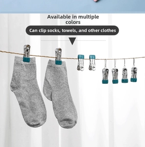 Close-up of stainless steel clothes pegs with blue non-slip pads for hanging small laundry