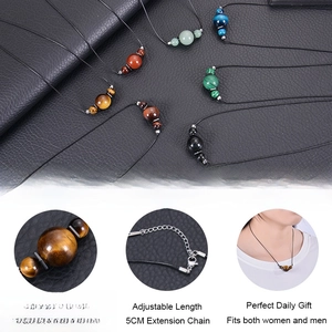 Detail of 16mm tiger eye stone pendant with adjustable cord clasp and model wearing view