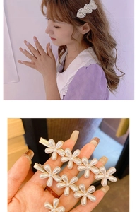 Detailed view of elegant pearl flower hair clips set on high-quality golden metal base