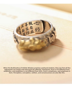 Macro detail of Heart Sutra ring showing Buddhist scripture engraving and vintage relief