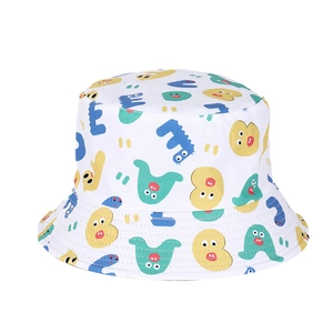 Close-up of white bucket hat featuring colorful cartoon monster patterns in vibrant colors