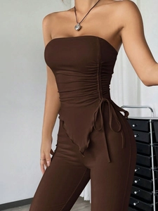 Detail of dark brown two-piece set featuring tube top with side drawstrings and slim fit pants