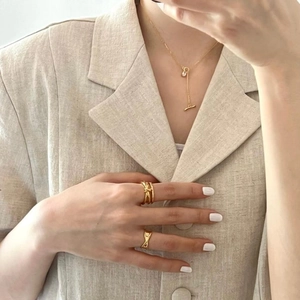 Detail of 925 sterling silver geometric zircon necklace with toggle clasp on model