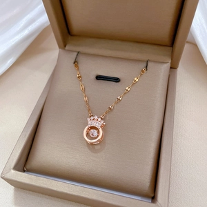 Elegant rose gold crown necklace with dancing diamond in a champagne gift box