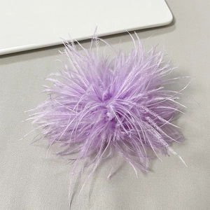 Macro detail of lavender ostrich feather brooch with soft texture and layered petals