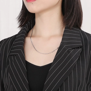 Close-up of minimalist silver stainless steel fine chain necklace on a model