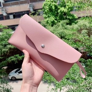 Pink envelope makeup brush clutch bag with textured finish and matching wrist strap