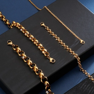 Detail of various 18K gold plated titanium steel chains with lobster clasps on dark blocks