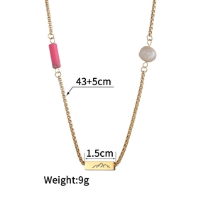 Detail view of 18K gold stainless steel necklace with bead, pearl and mountain pendant