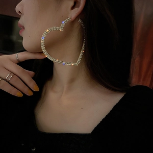 Exaggerated silver heart hoop earrings with sparkling rhinestones for a stylish look