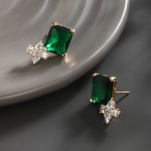 Detailed macro of vintage emerald green rectangular crystal earrings with marquise zircon stones