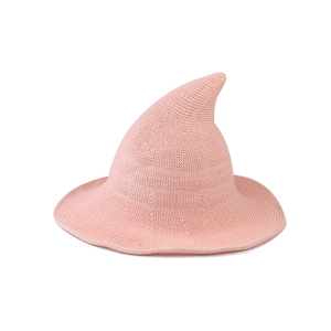 Detail of pink knitted witch hat showing soft woven texture and pointed wizard cap design