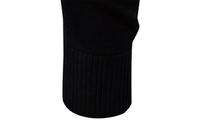 Close-up of the ribbed cuff on a black V-neck sweater showing fine knit craftsmanship