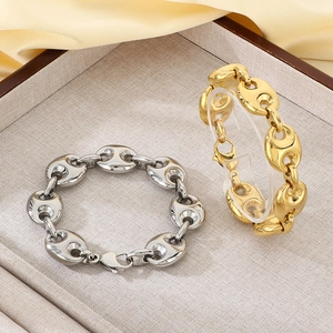 Detailed macro of polished 18k gold and silver pig nose chain bracelet with lobster clasp