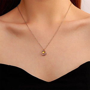 Rose gold crescent moon pendant necklace with yellow gemstone and sparkling zircons