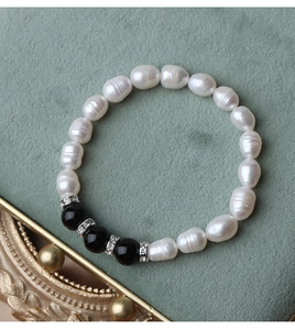 Detail of freshwater pearl bracelet with black agate beads and sparkling zircon spacers