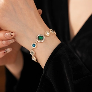 Detail of luxury colorful crystal bracelet on wrist with gold finish and vintage design