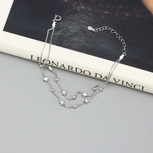 Detail view of the 925 sterling silver hallmark on double-layer star and bead bracelet