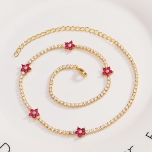 Detail of flower necklace with pink and white zircon crystals on gold-plated chain