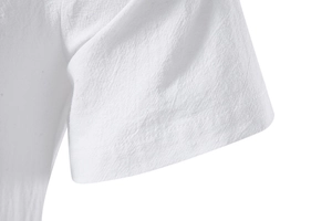 Detail of white cotton linen shirt sleeve showing natural texture and stitching quality